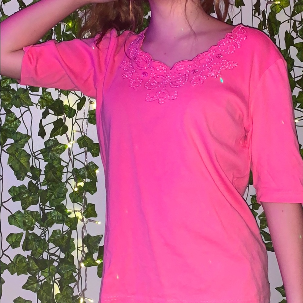 longer pink shirt with gems in the neckline